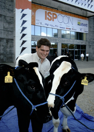 Winner, Donny Simonton, poses with Tucows' two cows at ISPCon in San Diego.